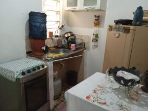 a small kitchen with a sink and a stove at CasaSueli in Aparecida