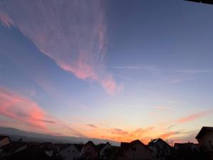 a sunset over a city with houses and buildings at Casa DaLi in Sibiu