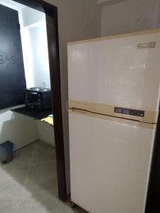 a white refrigerator in a room with a counter at Depto Cabildo in San Salvador de Jujuy