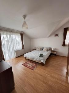 a bedroom with a bed and a large window at Casa DaLi in Sibiu