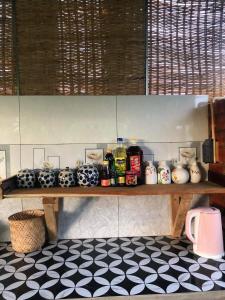 a shelf with vases on it in a kitchen at Huong Sen Garden lodge in Xóm Bãi Trại +38 photos