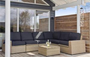 a blue couch sitting on a screened porch at Awesome Home In Idestrup With Sauna in Marielyst