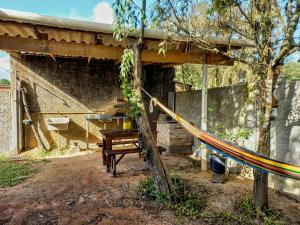 a building with a hammock in front of it at Casa Container á 3minutos da Lagoa in Tapes