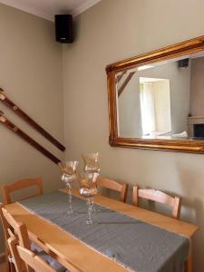 a table with wine glasses on it with a mirror at Galini Retreat in Klitoria +11 photos