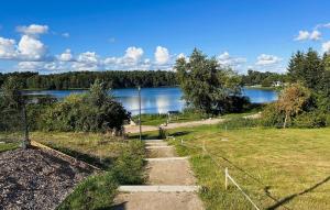 a path leading to a field next to a lake at Amazing Home In Klütz With Kitchen in Klütz