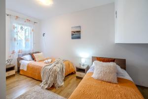 a bedroom with two beds and a window at Apartment Milna - with Swimming Pool & Amazing Seaviews, above Bijaka Beach in Milna +291 photos