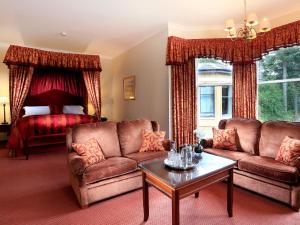 a living room filled with furniture and a window at Macdonald Norwood Hall Hotel in Aberdeen