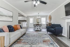 a living room with a couch and a chair at Charming Farmhouse Retreat in Madison AL in Madison