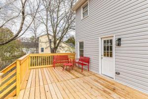 a wooden deck with two red chairs on it at Charming Farmhouse Retreat in Madison AL in Madison