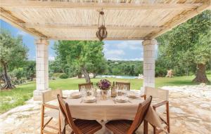a table under a pergola with a table and chairs at Beautiful Home In Ostuni -Br- in Ostuni