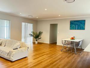 a living room with a bed and a table at Cindy garden in Perth