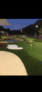 a view of a golf course with a green at Cindy garden in Perth