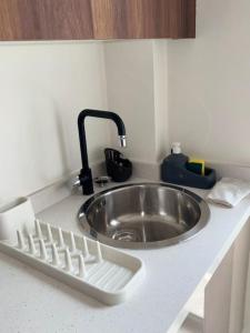 a kitchen counter with a sink and a faucet at 35 Appartement ensoleillé calme et NEUF in Casablanca