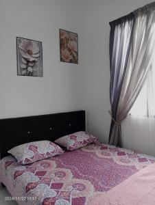 Postel nebo postele na pokoji v ubytování Nana Homestay