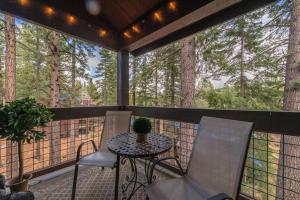 a screened in porch with a table and chairs at Luxury 3 BDR Northstar Condo in Truckee