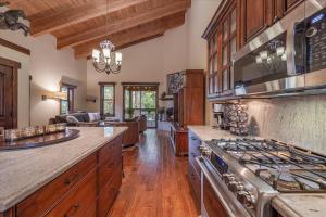 a kitchen with a stove and a living room at Luxury 3 BDR Northstar Condo in Truckee