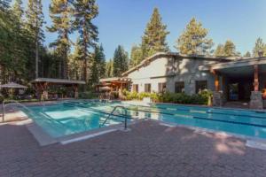 a large swimming pool in front of a house at Luxury 3 BDR Northstar Condo in Truckee