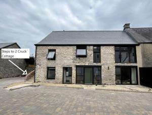 a brick building with a sign that says step to a quick garage at 2 Cruck Cottage, Cowbridge in Cowbridge