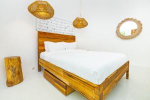 a bedroom with a bed and a mirror and lights at Igloo Beach Lodge in Manuel Antonio