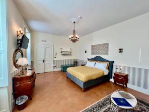 a bedroom with a bed and a tv in it at Casa Santangelo Suites in Salerno