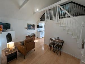 a living room with a couch and a staircase at Willamette Cottage in Salem