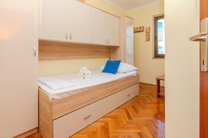 a bed in a small room with white cabinets at Family friendly house with a parking space Privlaka, Zadar - 23633 in Privlaka