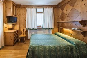 En eller flere senge i et værelse på Hotel Natale