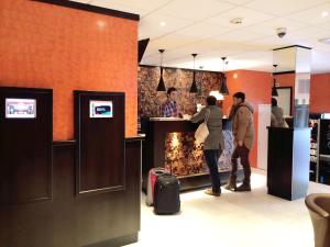 a group of people standing at a counter in a store at Mozart Hotel in Amsterdam +28 photos