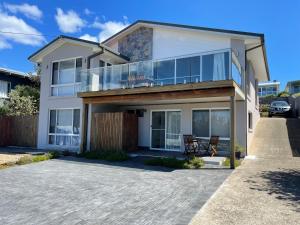 a house with a large balcony on a driveway at Waterfront and direct beach access with views in Ulladulla +11 photos