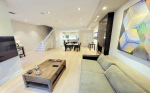 a living room with a couch and a table at Modern 1 block from Metro subway Minutes to Capital, Museums and National Mall in Washington