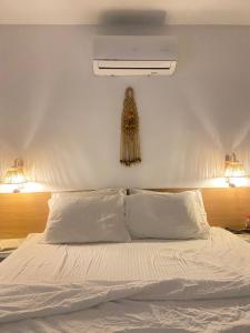 a bedroom with a white bed with a white ceiling at Casa Macao Tibau do Sul in Tibau do Sul +24 photos