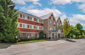 a large brick building with a street in front of it at Extended Stay America Suites - Indianapolis - West 86th St in Indianapolis