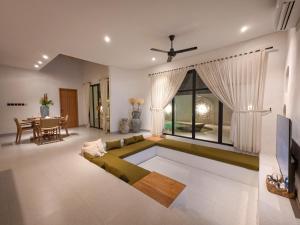 a living room with a couch and a table at Miko Villa Seminyak in Seminyak