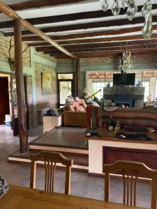 a living room with a table and a couch at Posada Sausalito in Santa Rosa de Calamuchita