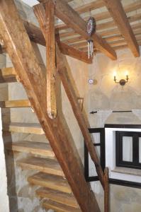 a staircase in a room with wooden beams at Casa Andrea in Vejer de la Frontera