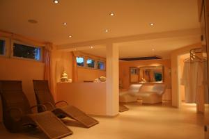 a living room with a couch and a table at Hotel Landhaus Waldesruh in Freudenstadt