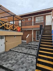 a stairway leading to a building with a stair case at Caleta Olivia Ancla alojamiento departamento in Caleta Olivia