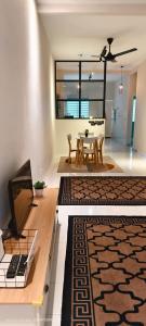 a living room with a table and a dining room at THE Nadraa GUESTHOUSE KLIA in Sepang