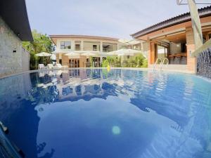 a large swimming pool in front of a house at Pearl Vista de Coron Resort Hotel in Coron