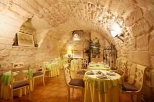 a restaurant with tables and chairs in a stone building at Hôtel Beaubourg in Paris