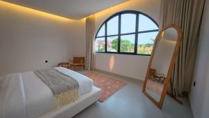 a bedroom with a bed and a large window at Miko Villa Seminyak in Seminyak +80 photos