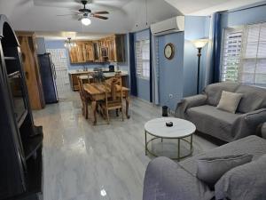 a living room with a couch and a table at Soleil Paradise Palms in Priory