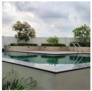 a pool of water with trees on top of a building at The Daffodils Apartment in Trivandrum