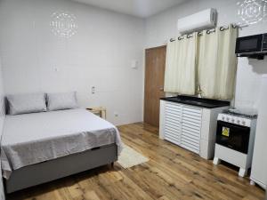 una piccola camera con letto e piano cottura di Casa de um cômodo tudo novo no boqueirão praia grande a Praia Grande