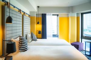 Postel nebo postele na pokoji v ubytování Hotel Resol Yokohama Sakuragicho