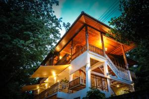 una casa con una cubierta alrededor por la noche en วิลล่า ป่าเหมี้ยง Villa Pa Miang, en Ban Pa Miang