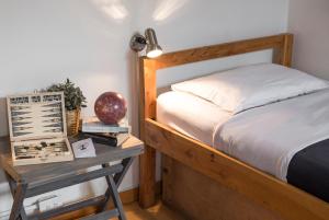 a bedroom with a bed and a table with a night stand at Explora Hostels in Bogotá