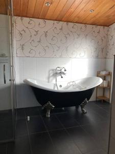 a bathroom with a large tub in a room at Kingfisher cottage in Hurunui