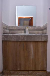 a bathroom with a sink and a mirror at Taji Two bedroom lovely apartment in Malindi +71 photos