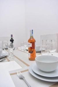 a table with a bowl and a bottle of wine at Taji Two bedroom lovely apartment in Malindi